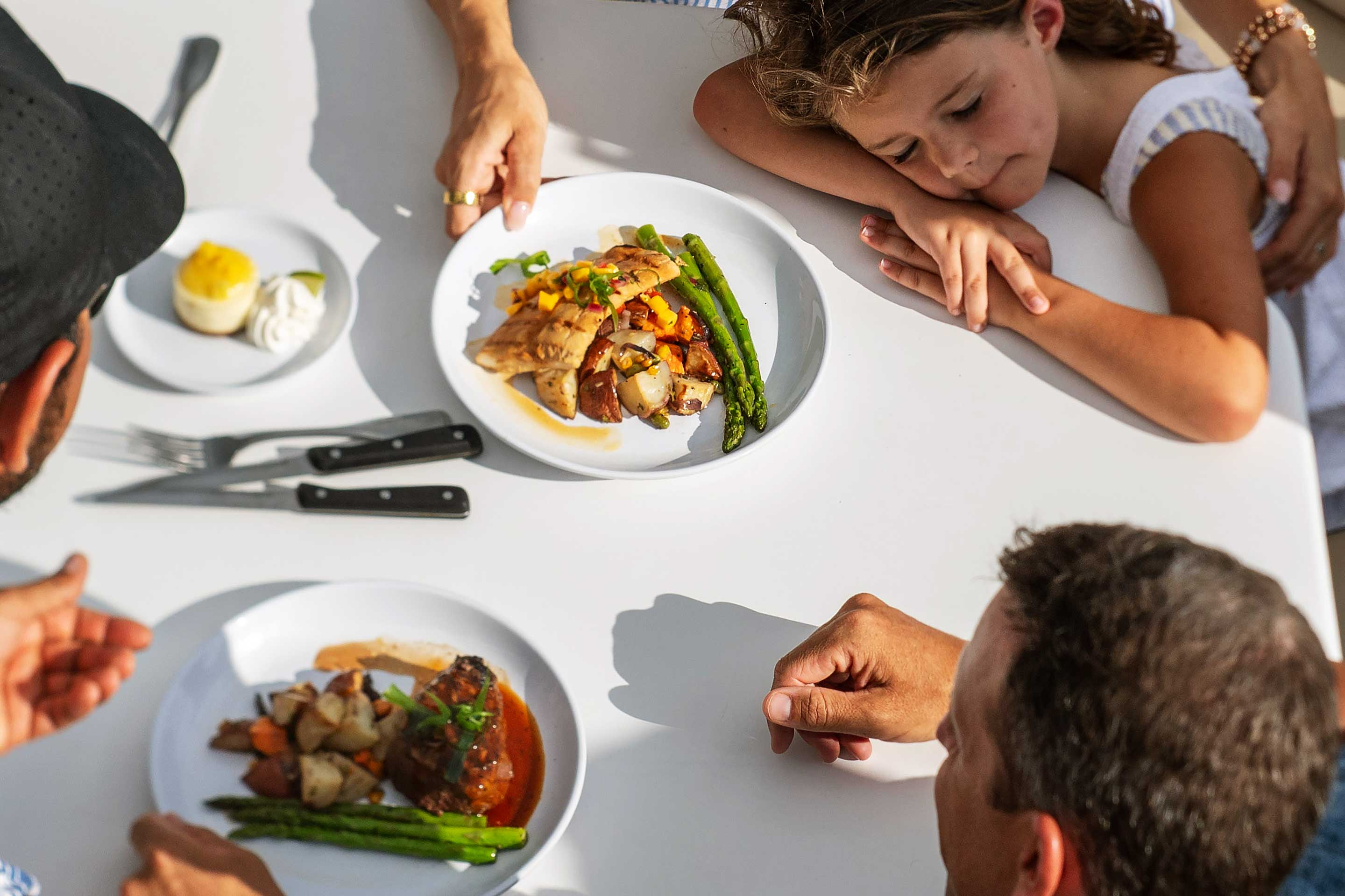Daughter sleeping while parents are served gourmet dinner on a Star Class Yacht