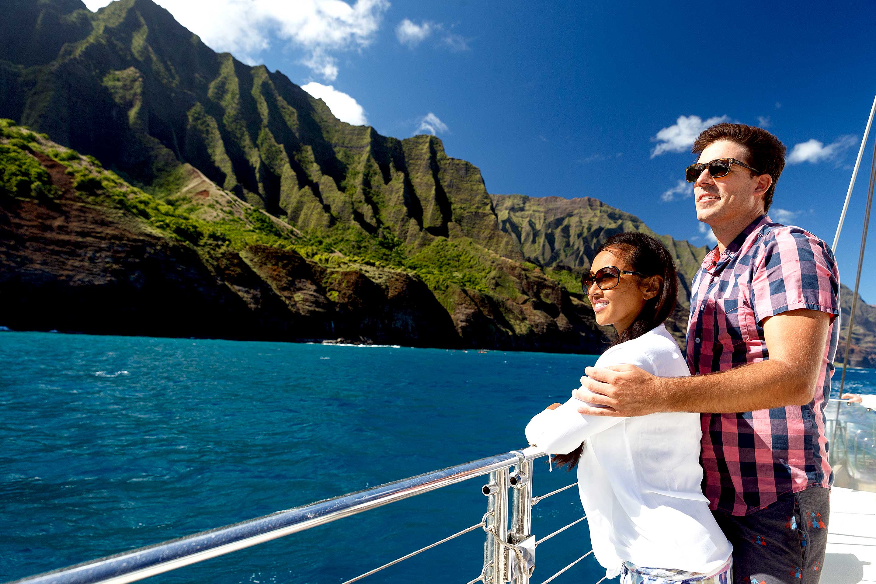 People sightseeing Na Pali Kauai from a luxury Star yacht.